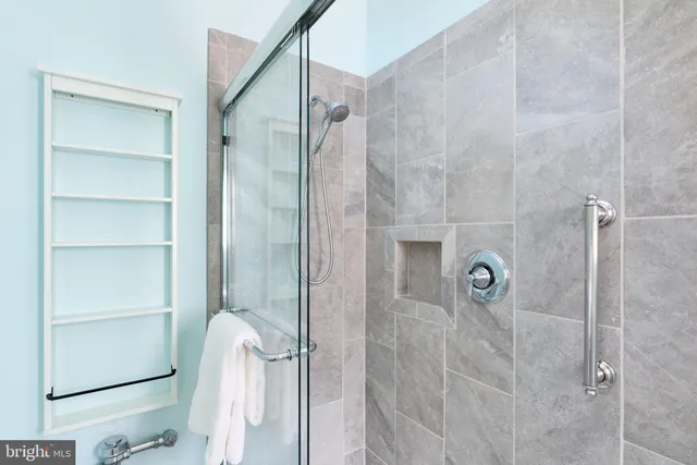 a bathroom with a granite countertop shower