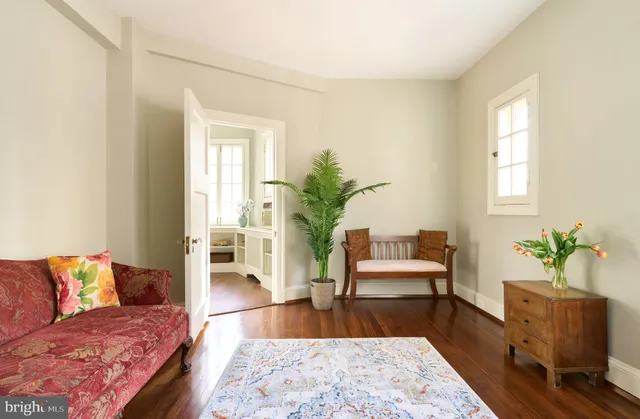 a living room with furniture rug and wooden floor