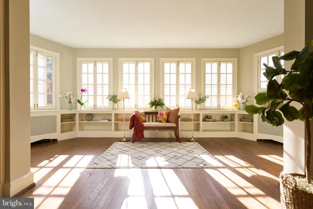 a living room with a couch and a table with wooden floor