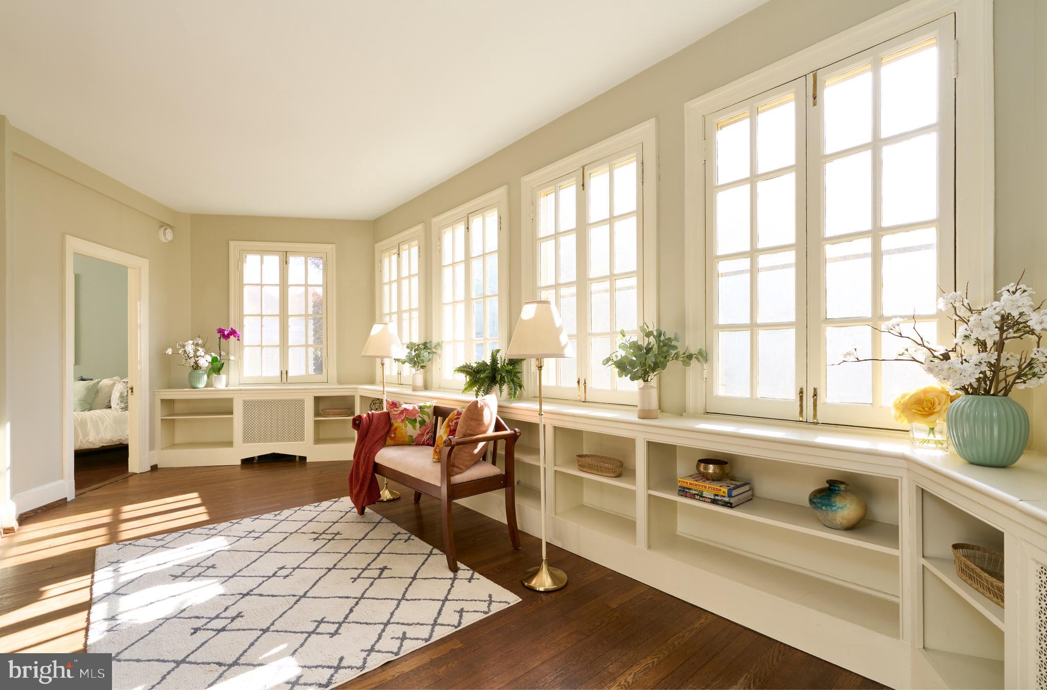 221 Stony Run Lane, Unit J2 Baltimore, MD 21210 - Photo 7 of 31 a living room with furniture large window and wooden floor