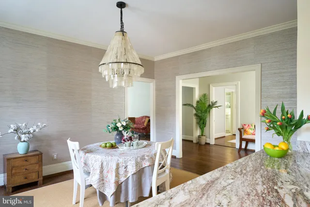 a dining room with furniture a chandelier and wooden floor