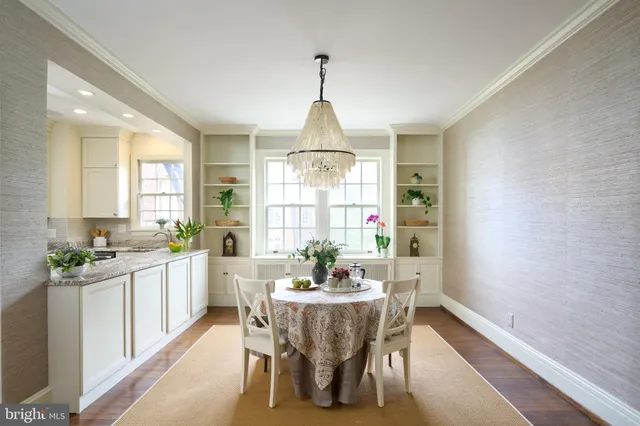 a dining room with furniture window and wooden floor