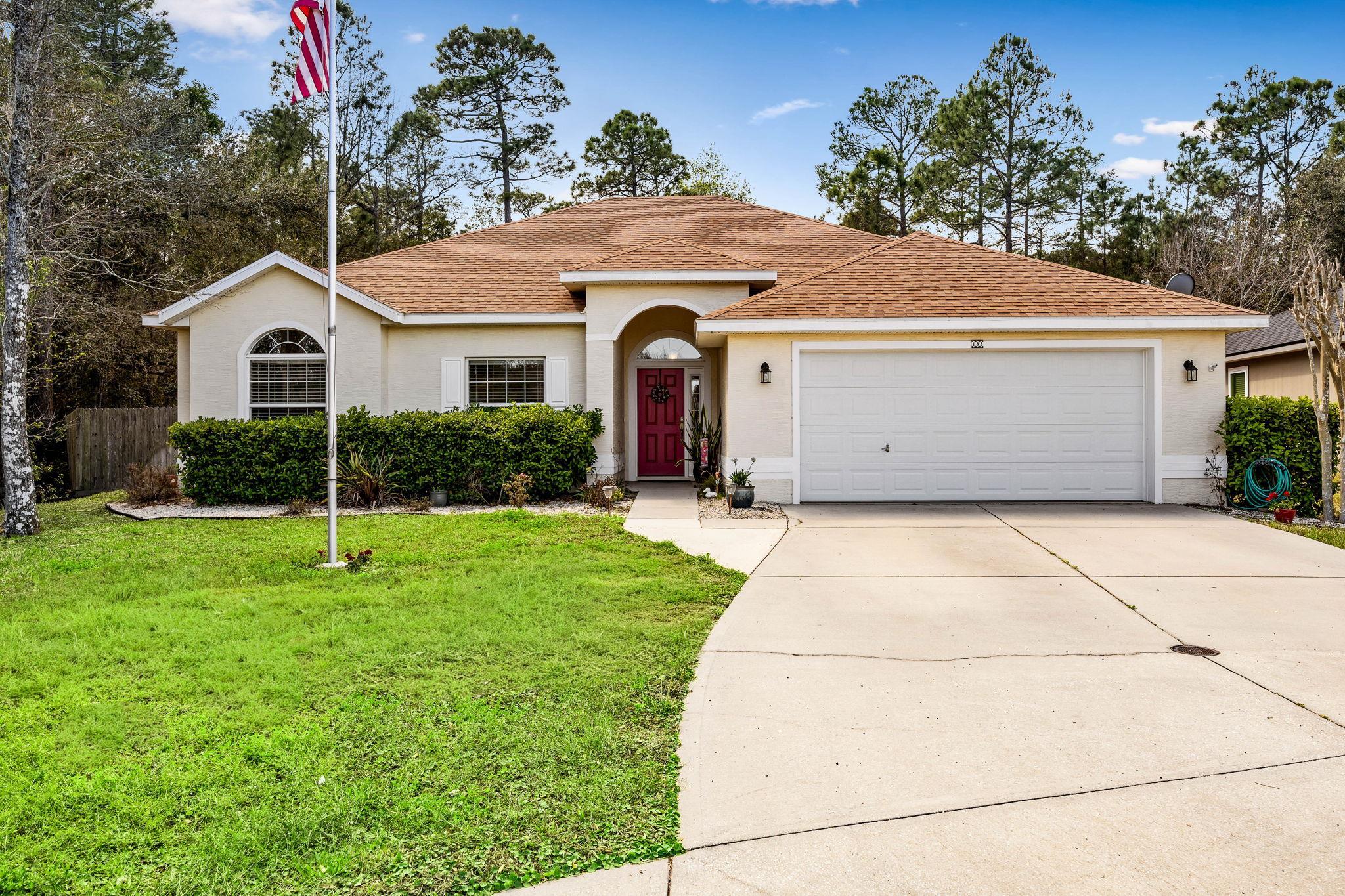 View of front facade featuring roof with shingles, a garage, stucco siding, and concrete driveway
