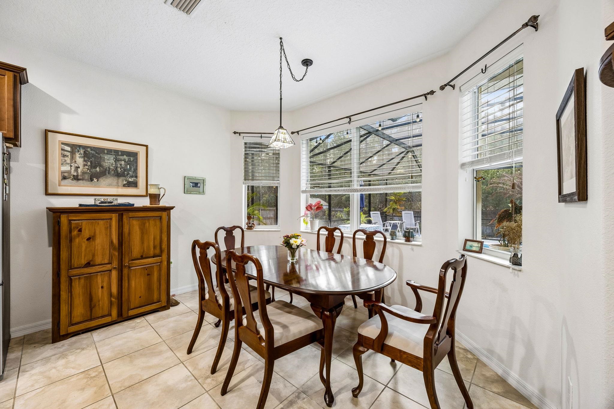 133 South Twin Maple Road St. Augustine, FL 32084 - Photo 10 of 34 Dining space with light tile patterned floors and baseboards