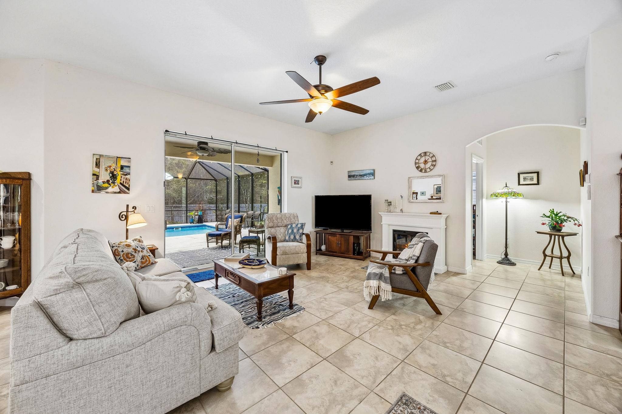 133 South Twin Maple Road St. Augustine, FL 32084 - Photo 12 of 34 Living area with a sunroom, ceiling fan, and light tile patterned flooring