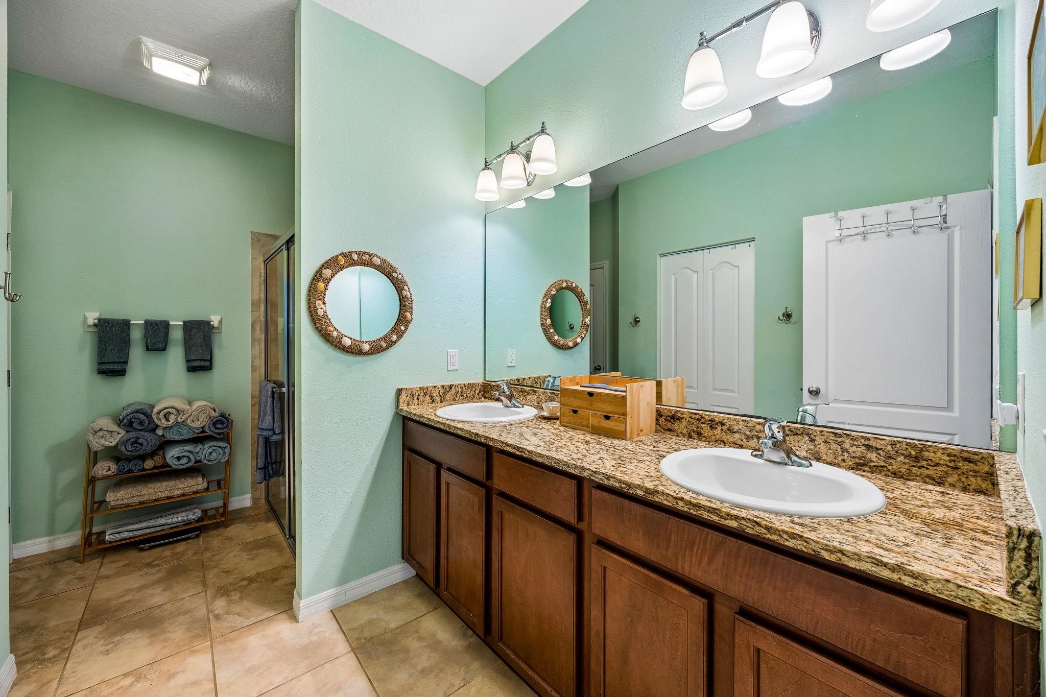 133 South Twin Maple Road St. Augustine, FL 32084 - Photo 17 of 34 Bathroom featuring double vanity, a shower stall, and light tile patterned floors