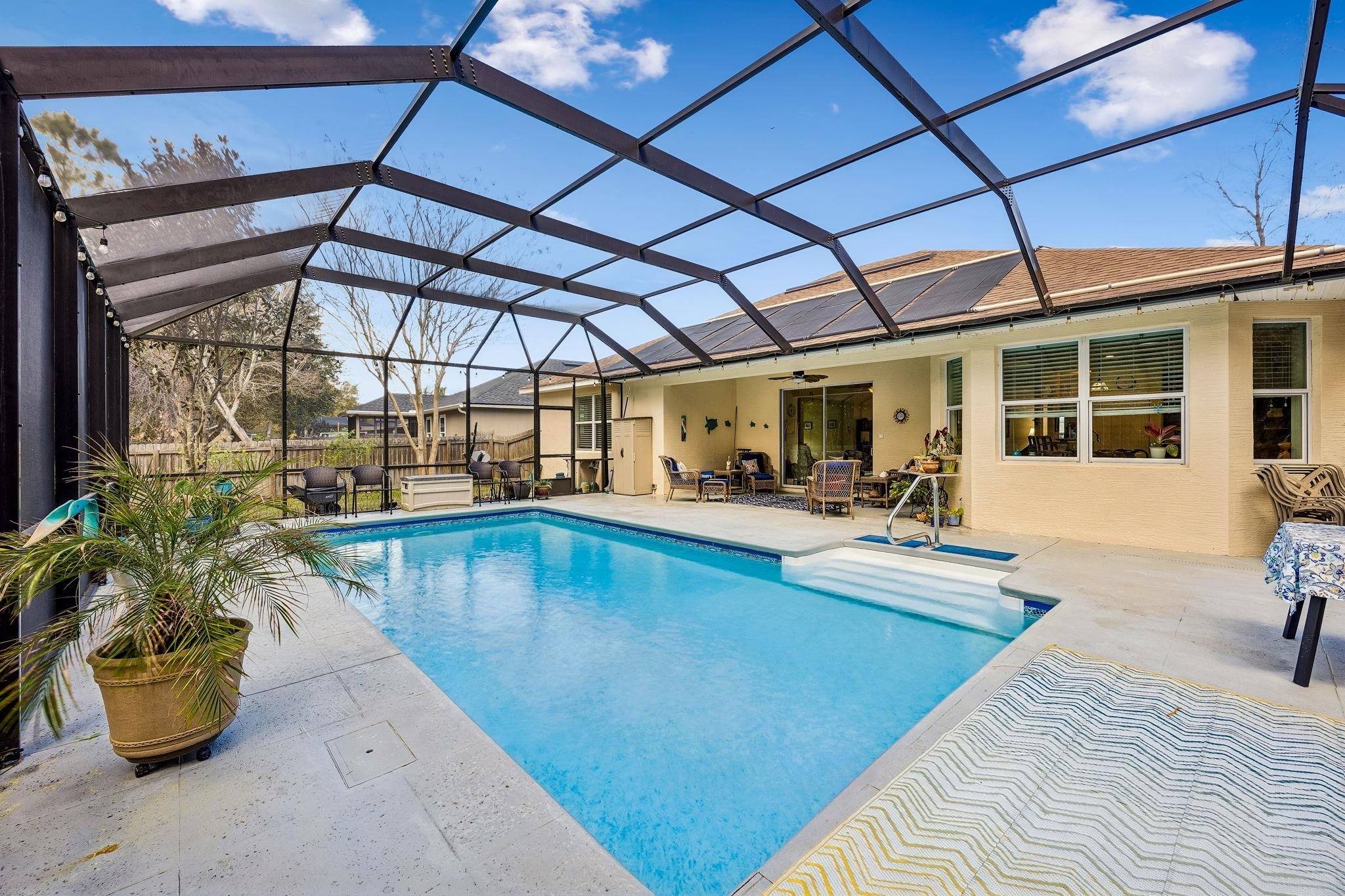 133 South Twin Maple Road St. Augustine, FL 32084 - Photo 2 of 34 Swimming pool featuring a sunroom, a patio area, and a lanai