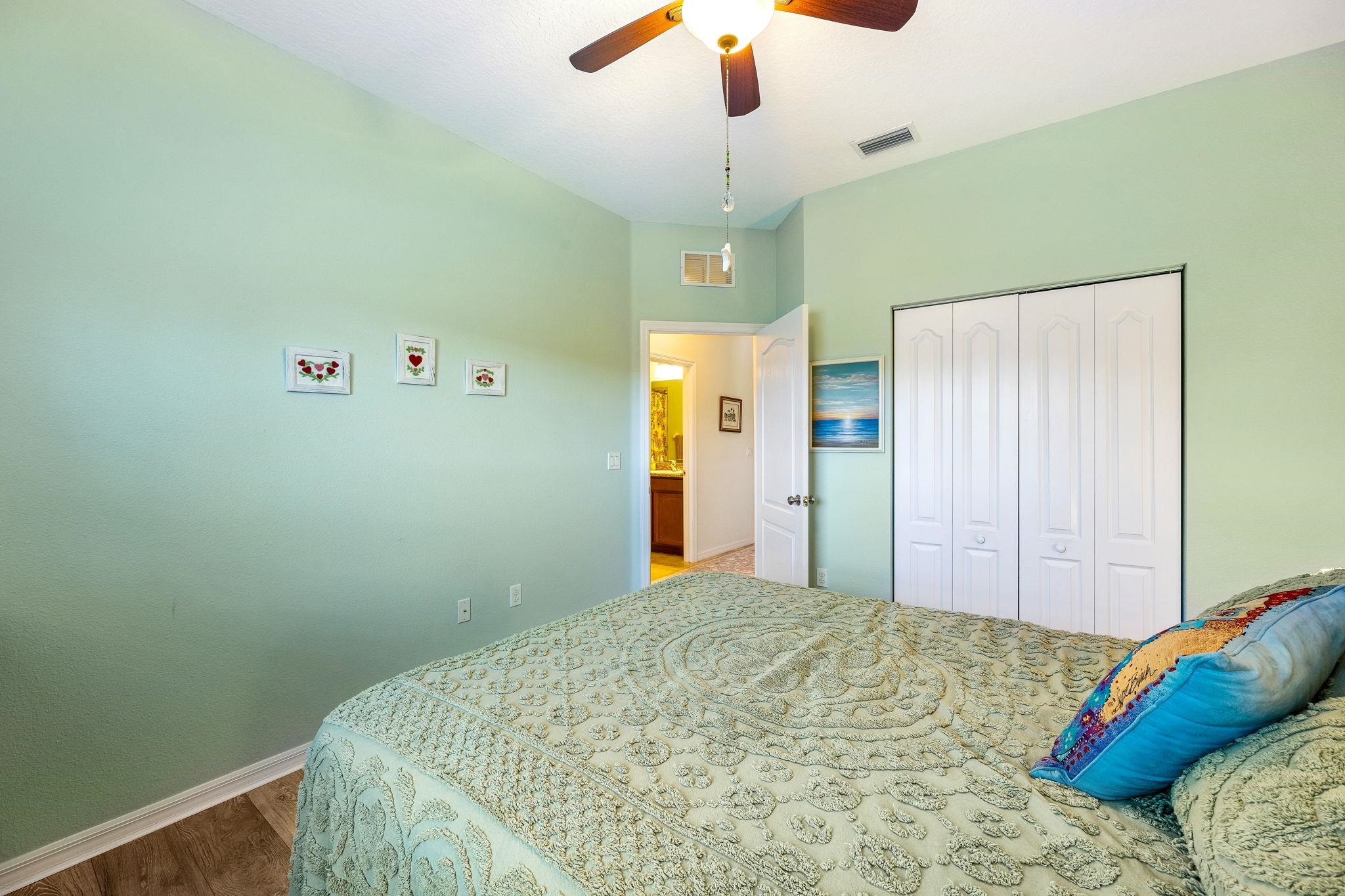 133 South Twin Maple Road St. Augustine, FL 32084 - Photo 23 of 34 a bedroom with a bed and a chandelier