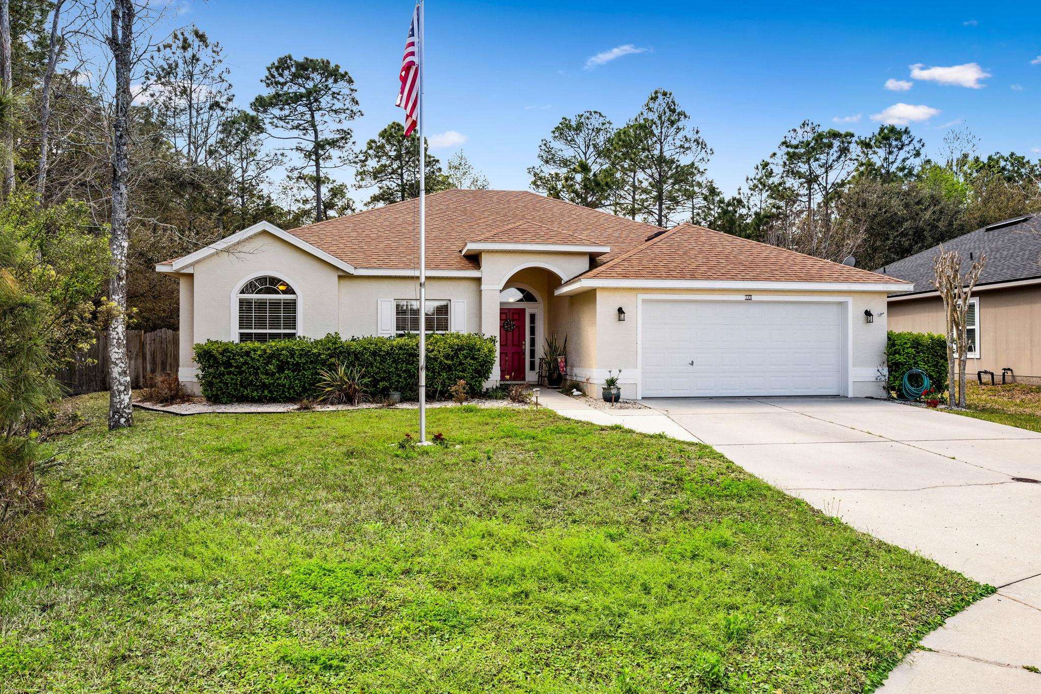 133 South Twin Maple Road St. Augustine, FL 32084 - Photo 29 of 34 View of front facade with a shingled roof, an attached garage, driveway, and stucco siding