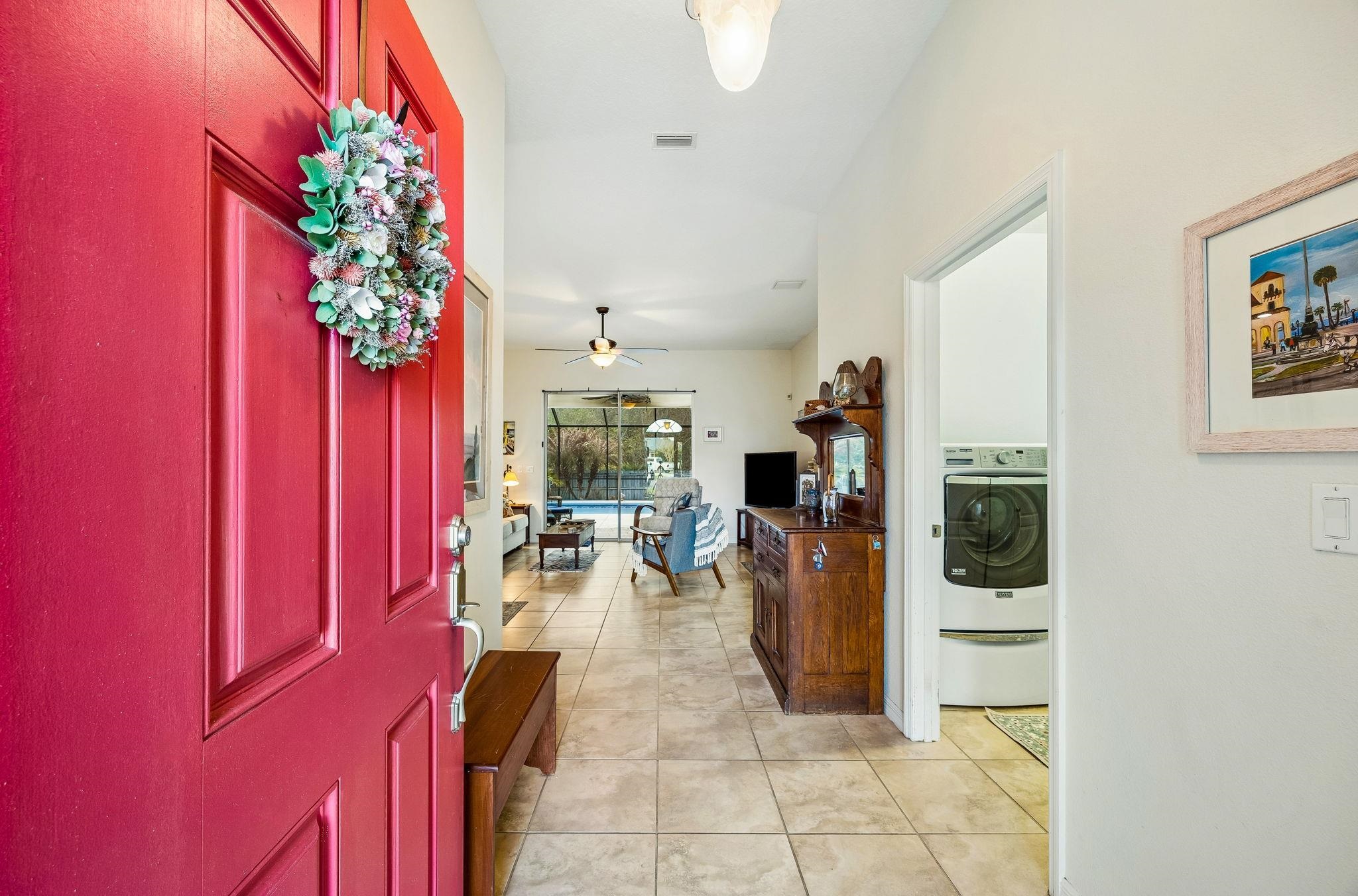 133 South Twin Maple Road St. Augustine, FL 32084 - Photo 5 of 34 Entrance foyer featuring washer / dryer, a ceiling fan, and light tile patterned flooring