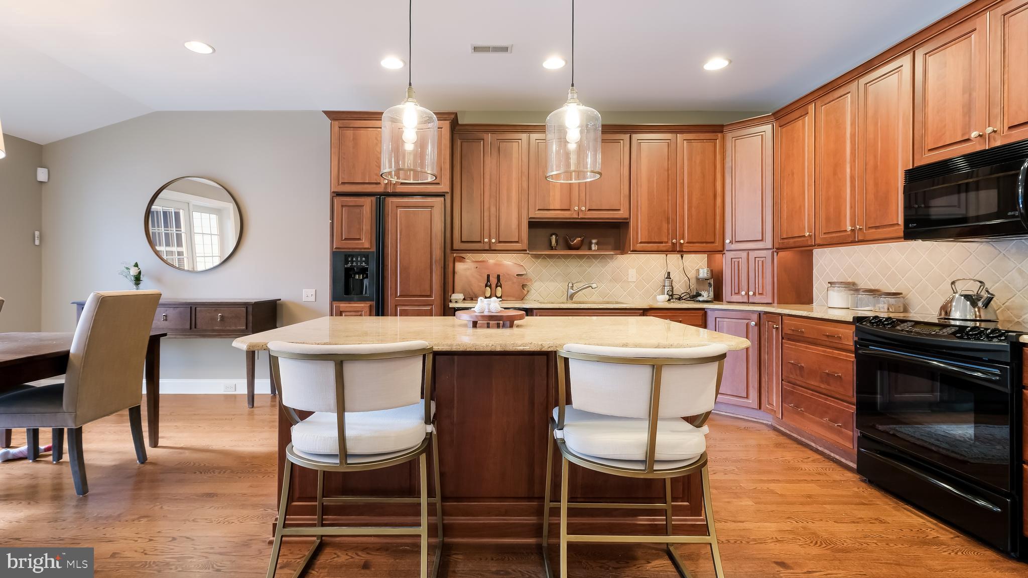 12 Garden Path Doylestown, PA 18901 - Photo 13 of 58 a kitchen with kitchen island granite countertop a sink and wooden cabinets