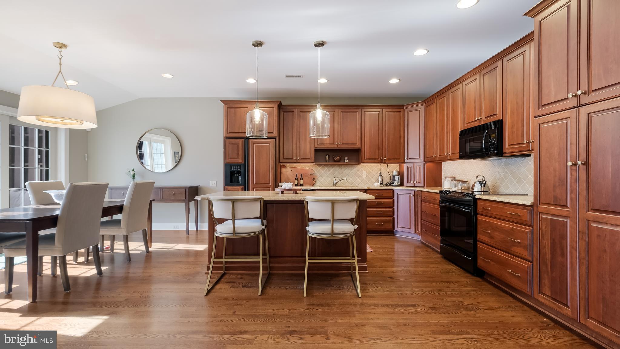 12 Garden Path Doylestown, PA 18901 - Photo 14 of 58 a kitchen with stainless steel appliances granite countertop a stove a refrigerator a kitchen island a dining table and chairs