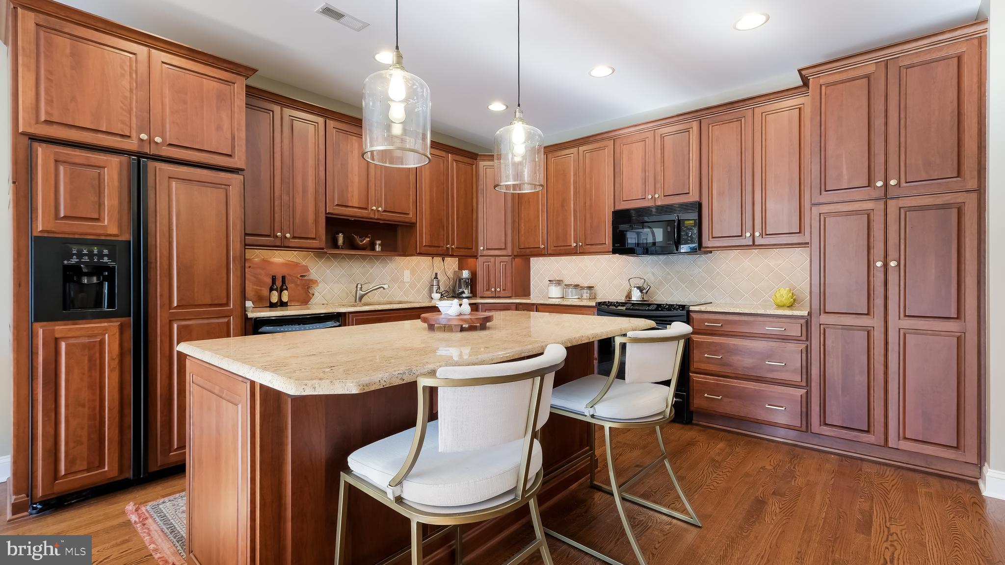 12 Garden Path Doylestown, PA 18901 - Photo 16 of 58 a kitchen with a refrigerator a stove top oven a sink dishwasher and wooden cabinets with wooden floor