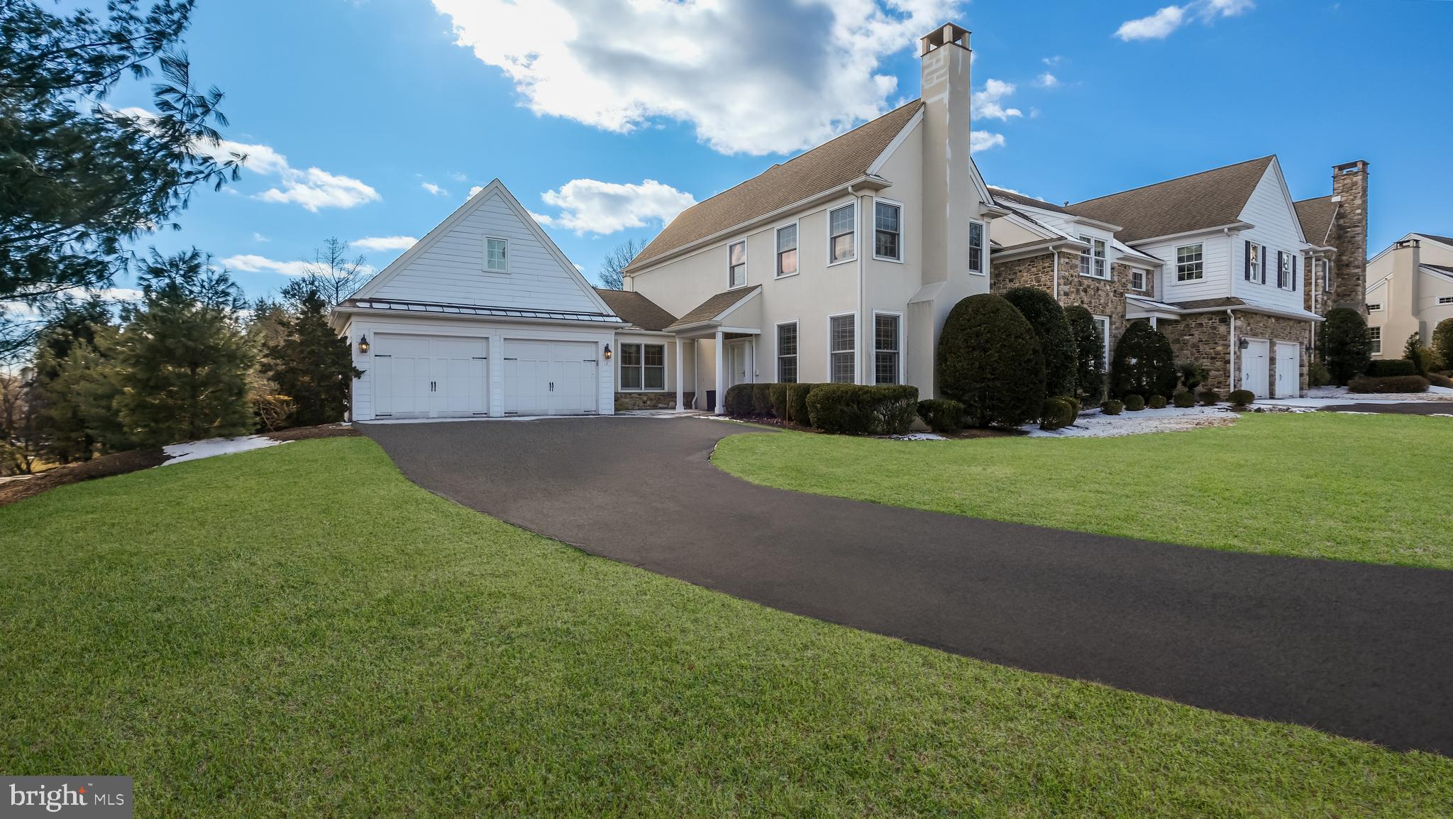 a front view of a house with a garden and yard