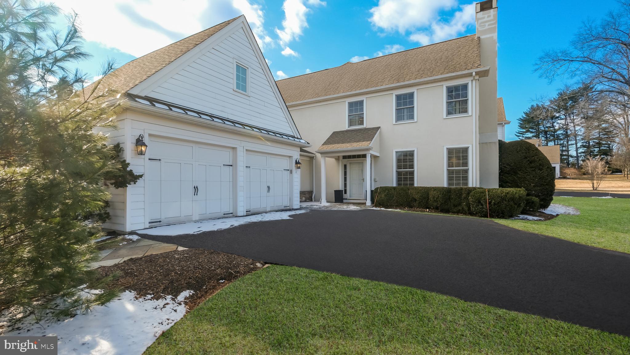 12 Garden Path Doylestown, PA 18901 - Photo 3 of 58 a front view of a house with a yard and garage