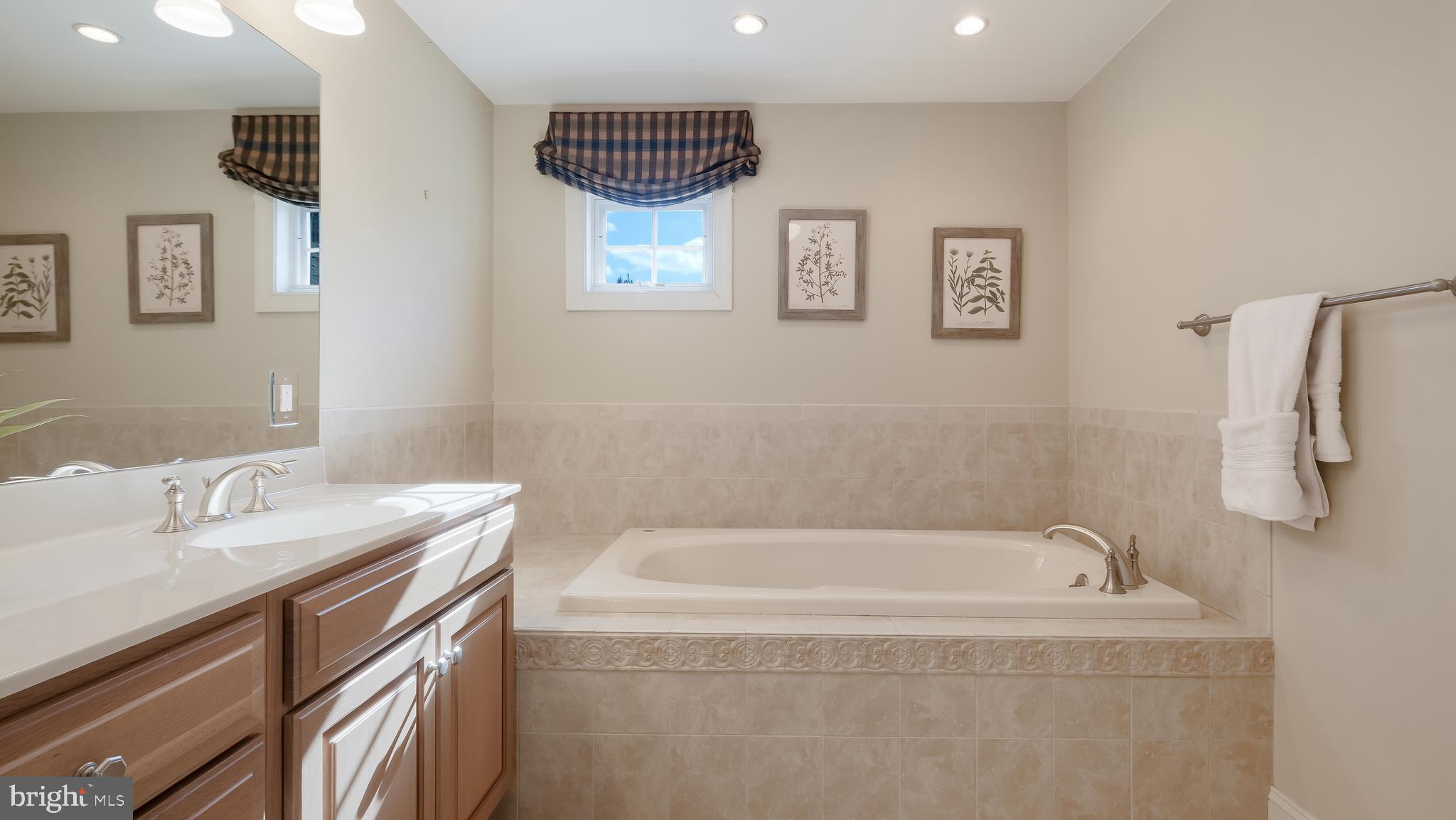 12 Garden Path Doylestown, PA 18901 - Photo 35 of 58 a bathroom with a tub sink and a mirror