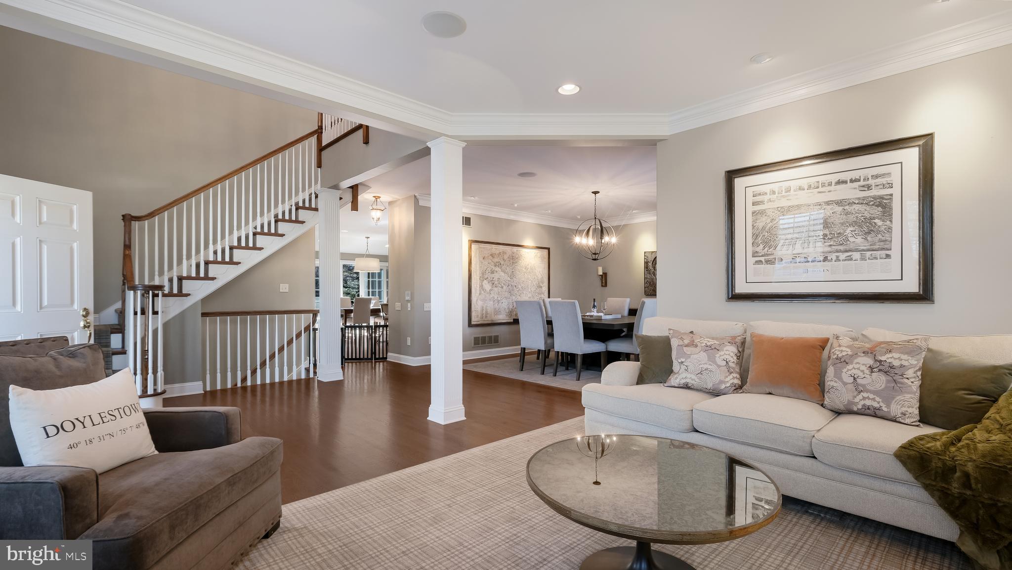 12 Garden Path Doylestown, PA 18901 - Photo 7 of 58 a living room with furniture and a dining table with wooden floor