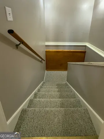 a view of an empty room with stairs