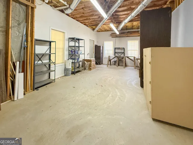 an empty room with a window and a ceiling fan