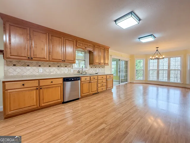 a view of a kitchen with a sink and wooden floor