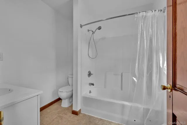 a bathroom with a shower and a toilet