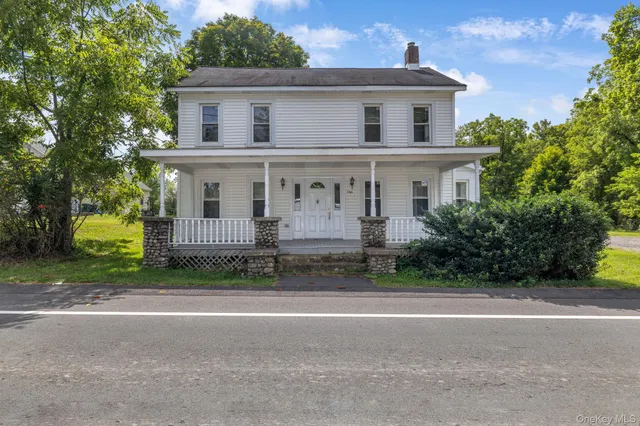 a view of house with outdoor space and parking