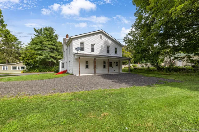 a view of house with outdoor space and yard