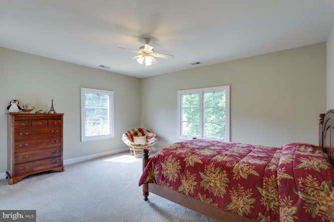 1193 Windrock Drive McLean, VA 22102 - Photo 17 of 30 a bed sitting in a bedroom next to a window and dresser