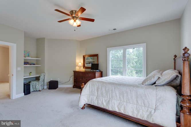 1193 Windrock Drive McLean, VA 22102 - Photo 19 of 30 a bedroom with a bed and a chandelier