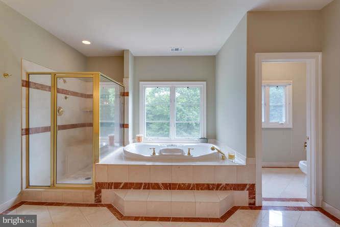 1193 Windrock Drive McLean, VA 22102 - Photo 24 of 30 a large bed sitting in a bedroom next to a window