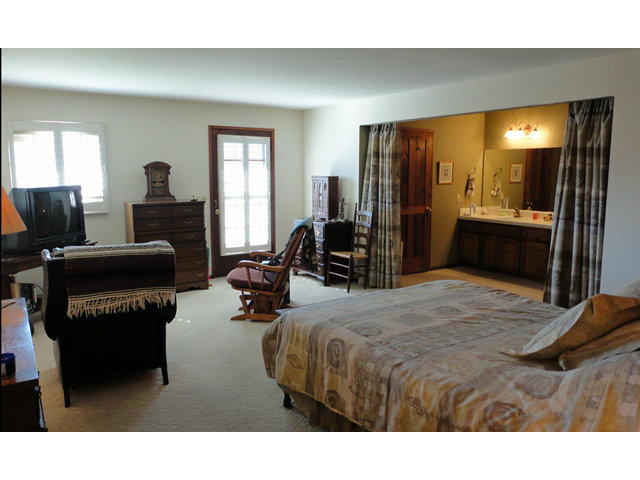 9970 Burchell Road Gilroy, CA 95020 - Photo 10 of 11 a bedroom with a bed a flat screen tv and dresser
