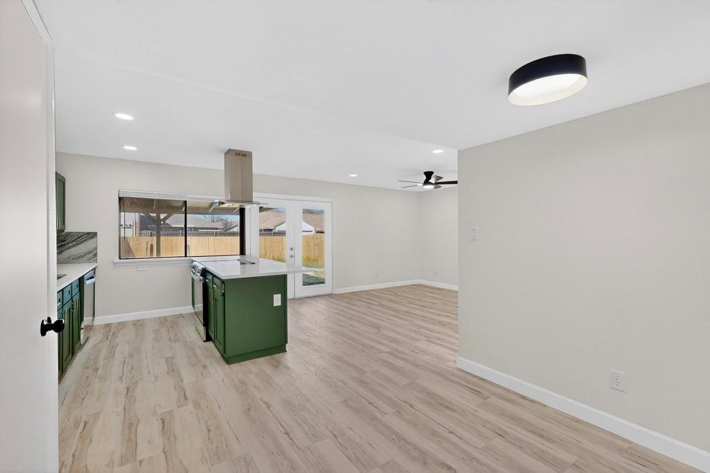 8505 Woodside Road Rowlett, TX 75088 - Photo 11 of 40 a room with wooden floor and windows