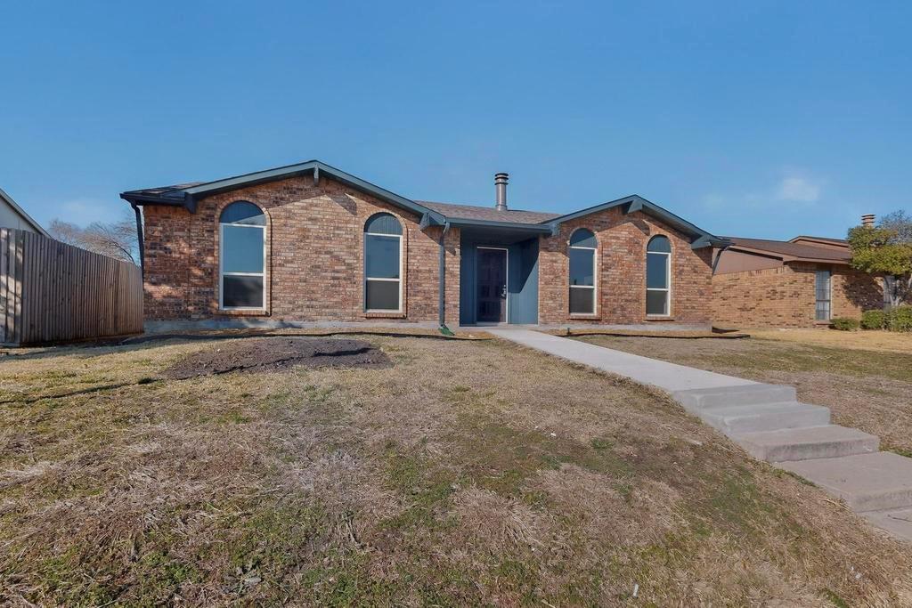 8505 Woodside Road Rowlett, TX 75088 - Photo 2 of 40 a view of a house with a yard