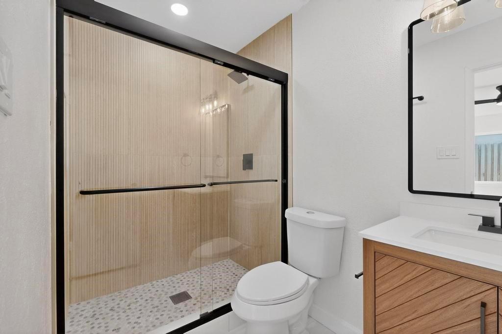 8505 Woodside Road Rowlett, TX 75088 - Photo 22 of 40 a bathroom with a sink toilet and shower