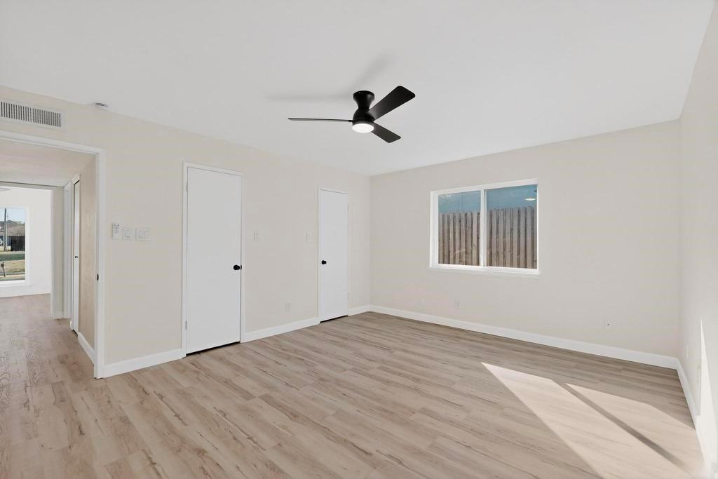 8505 Woodside Road Rowlett, TX 75088 - Photo 25 of 40 a view of empty room with wooden floor and fan