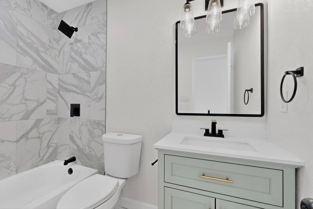 8505 Woodside Road Rowlett, TX 75088 - Photo 27 of 40 a bathroom with a sink a toilet and shower