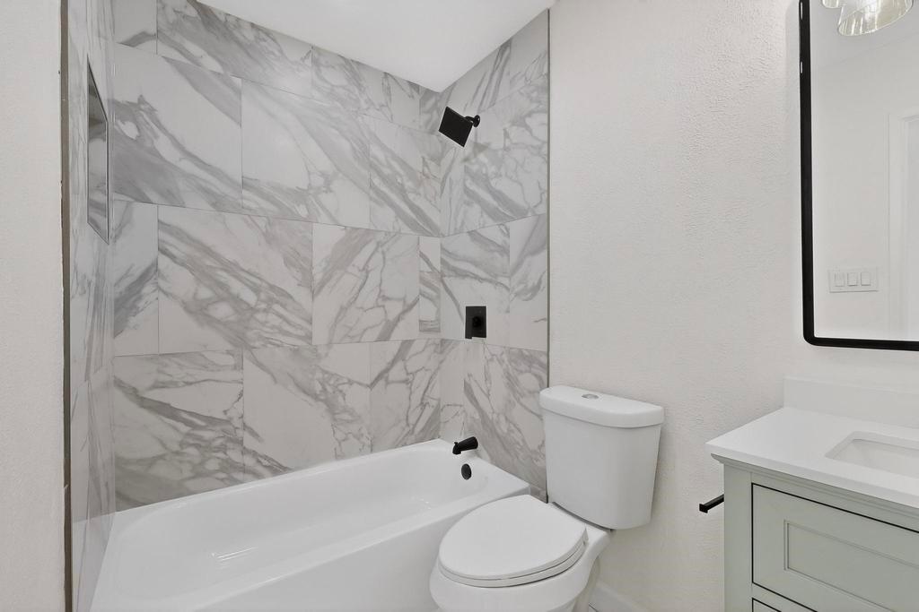 8505 Woodside Road Rowlett, TX 75088 - Photo 28 of 40 a white toilet sitting next to a bath tub