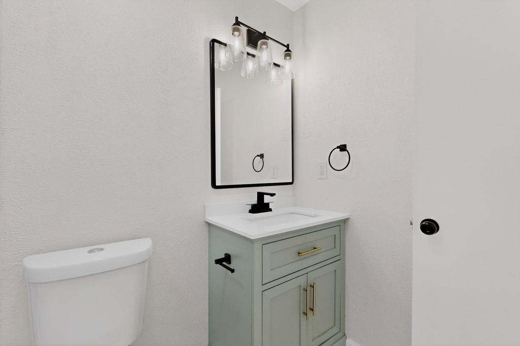 8505 Woodside Road Rowlett, TX 75088 - Photo 29 of 40 a bathroom with a sink and mirror with toilet
