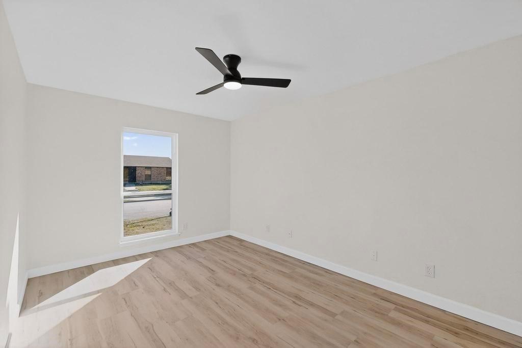 8505 Woodside Road Rowlett, TX 75088 - Photo 30 of 40 a view of empty room with wooden floor and fan