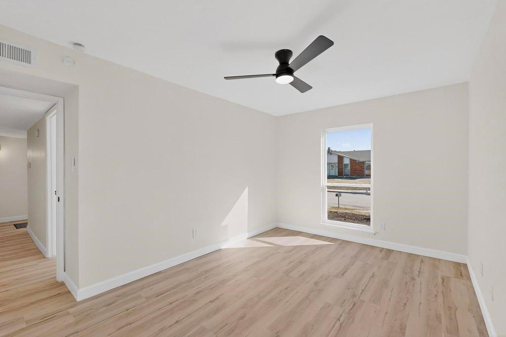 8505 Woodside Road Rowlett, TX 75088 - Photo 31 of 40 a view of empty room with wooden floor and fan