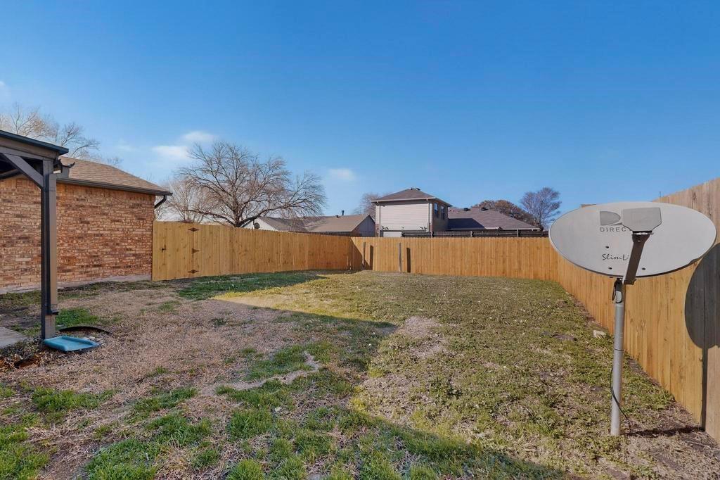 8505 Woodside Road Rowlett, TX 75088 - Photo 39 of 40 a view of a big room with a fireplace and table