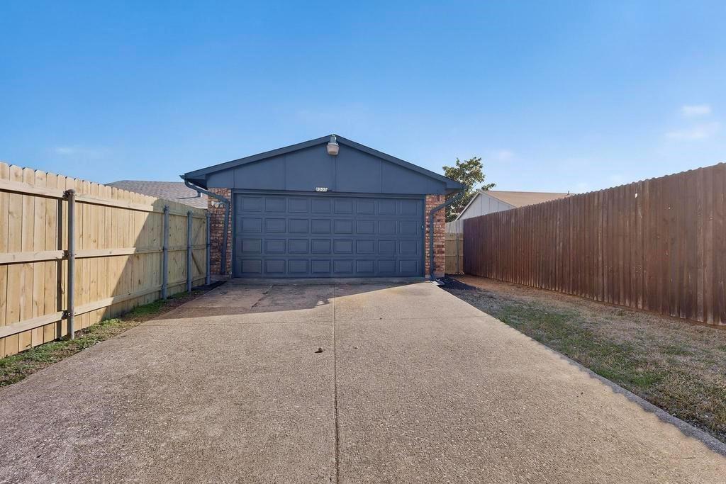 8505 Woodside Road Rowlett, TX 75088 - Photo 40 of 40 a front view of a house with a garage