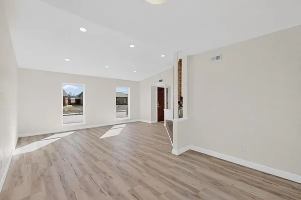 a view of a livingroom with wooden floor and window
