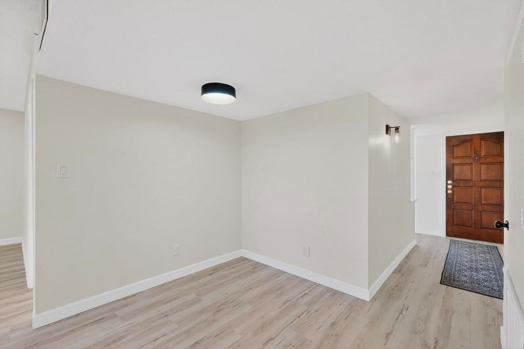 8505 Woodside Road Rowlett, TX 75088 - Photo 9 of 40 a view of an empty room with wooden floor and closet