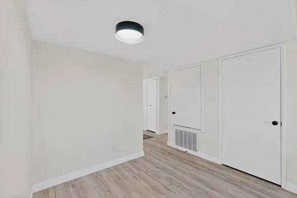 a view of a room with wooden floor