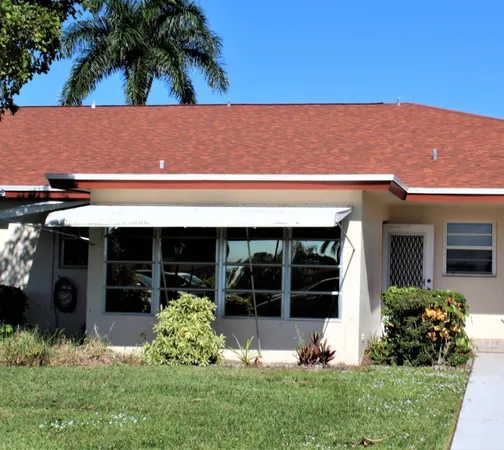 a view of a back yard of the house and a yard