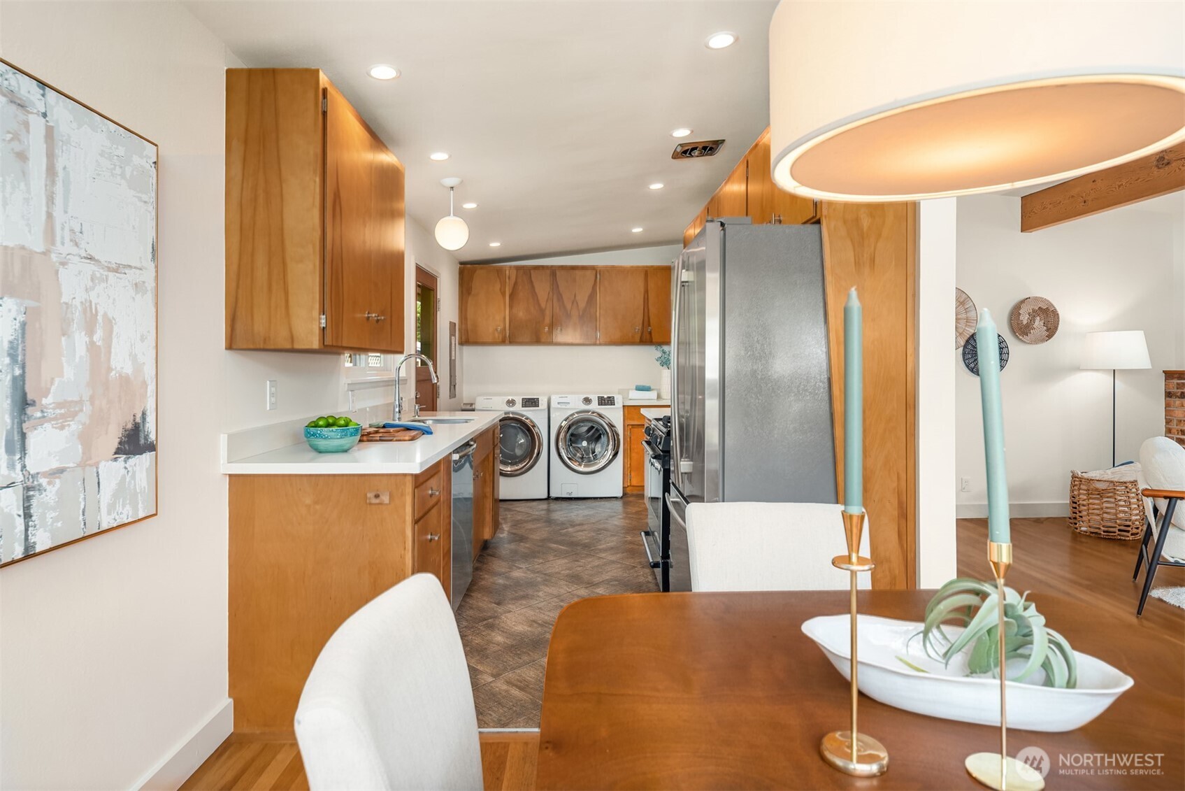 4714 50th Avenue Southwest Seattle, WA 98116 - Photo 14 of 34 a kitchen with stainless steel appliances kitchen island granite countertop a table chairs and a sink