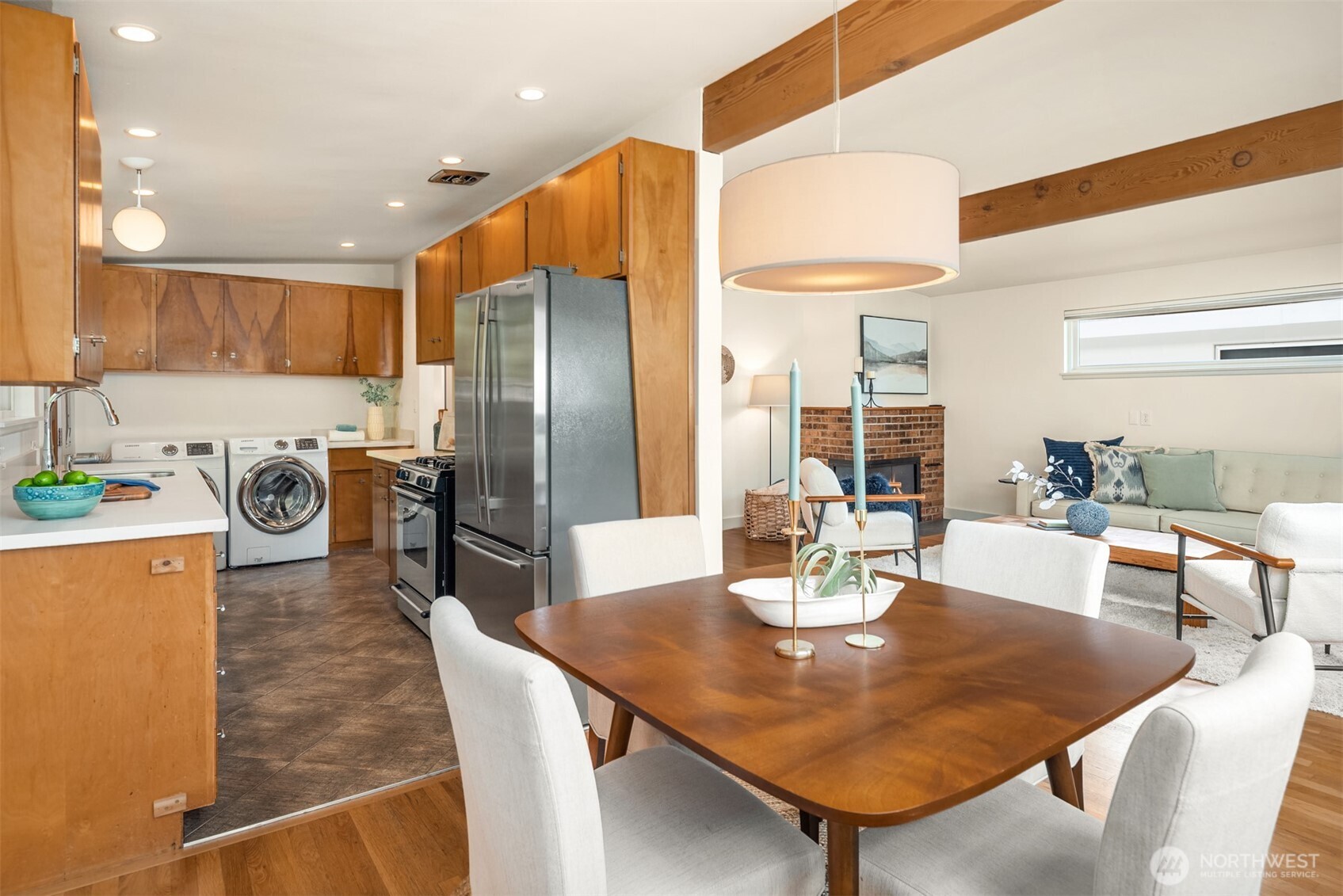4714 50th Avenue Southwest Seattle, WA 98116 - Photo 15 of 34 a kitchen with stainless steel appliances granite countertop a table chairs and a refrigerator