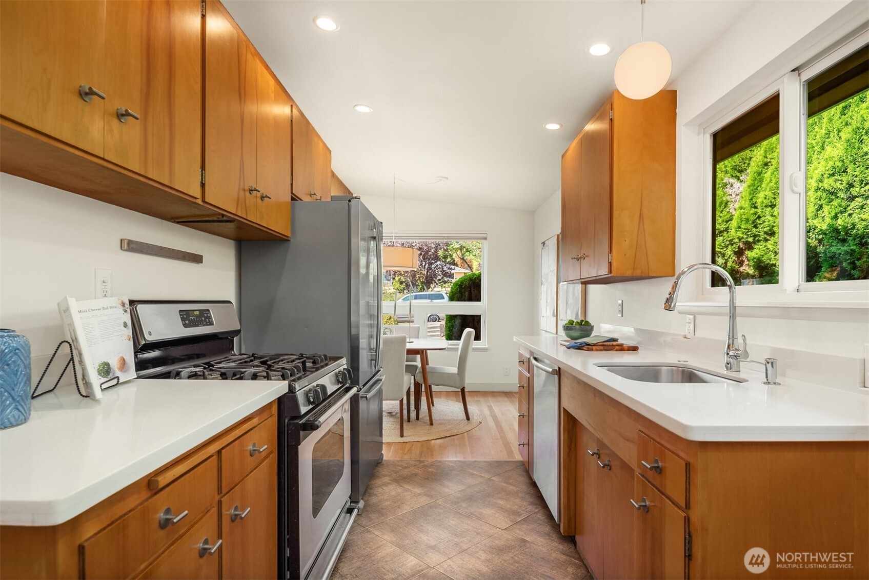 4714 50th Avenue Southwest Seattle, WA 98116 - Photo 16 of 34 a kitchen with a sink a stove and a cabinets