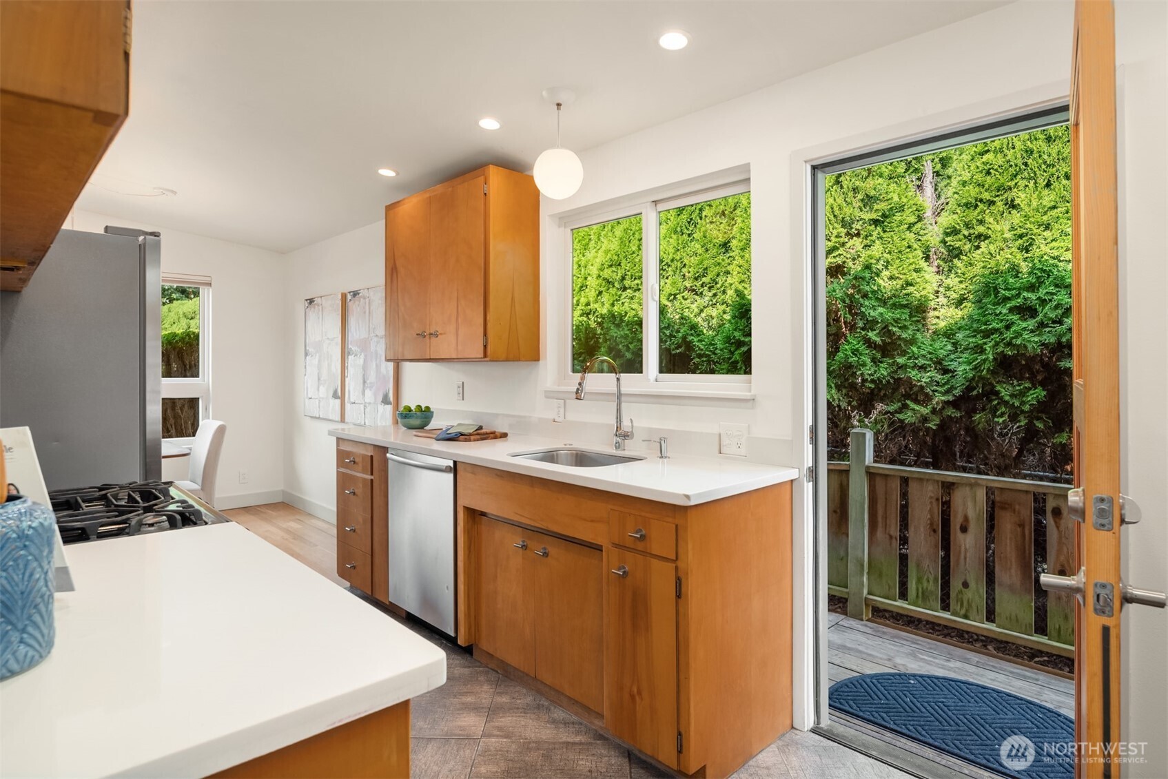 4714 50th Avenue Southwest Seattle, WA 98116 - Photo 18 of 34 a kitchen with a sink stove and cabinets